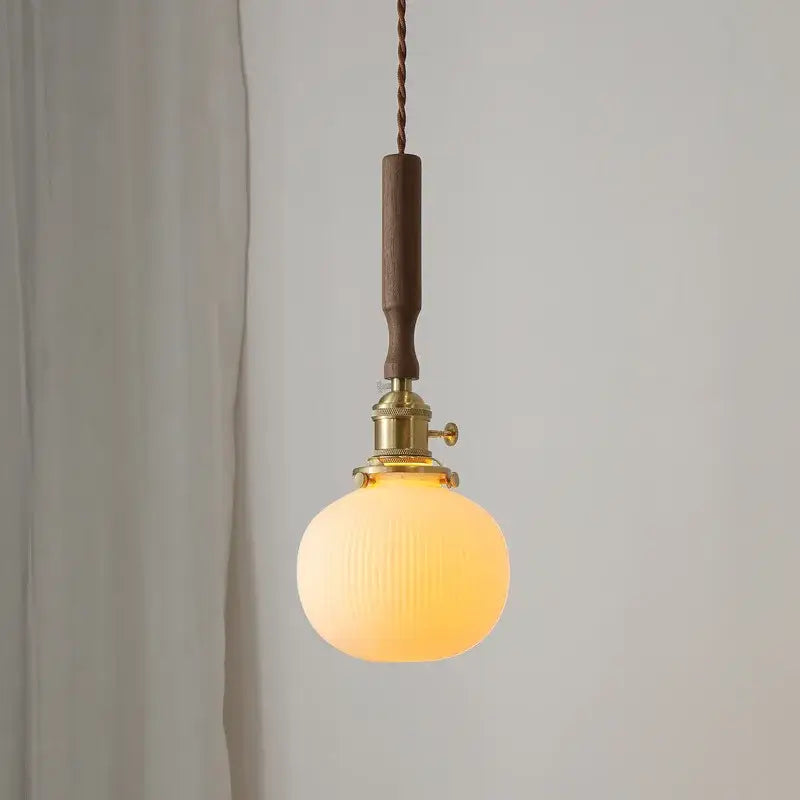 Warm-toned ceramic walnut copper ribbed glass pendant light with brass fixture and dark wood handle for bedroom decorbites ceramic walnut