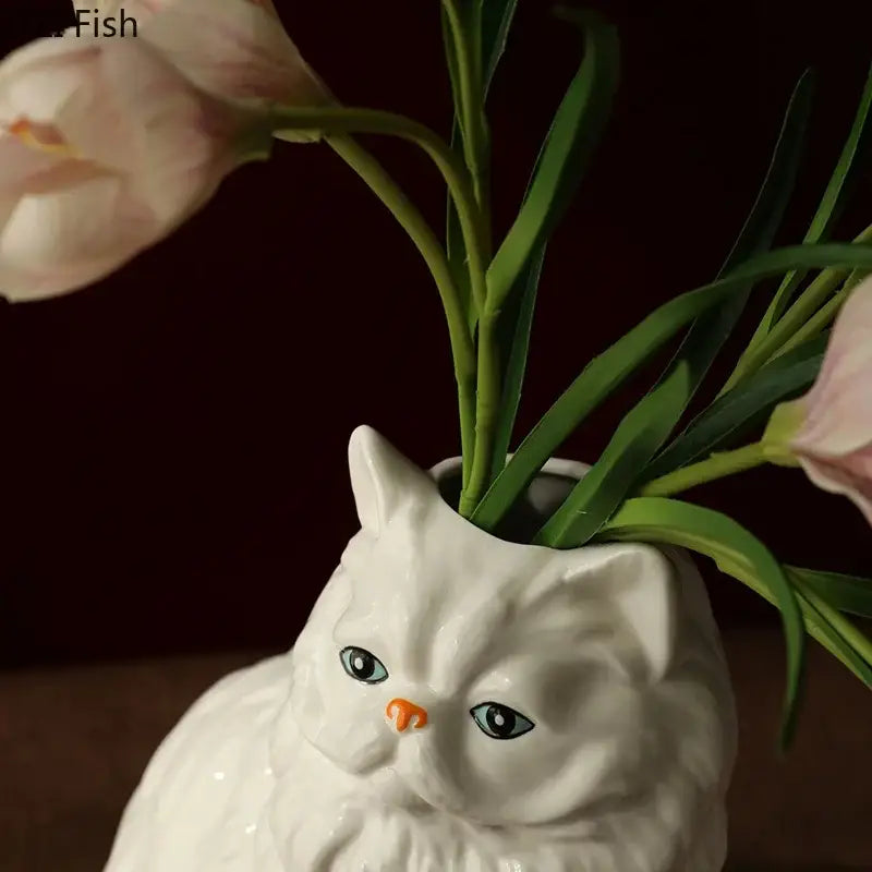 Ceramic white cat vase with blue eyes and orange nose holding pink tulips for desk and living room decorbites decor