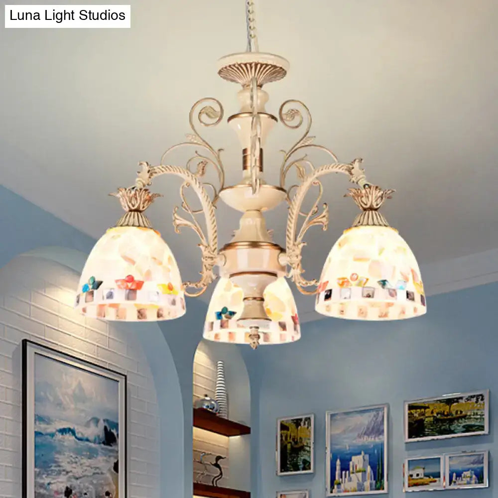 Cream-colored DecorBites™ chandelier with ornate metal arms and tiffany style stained glass mosaic shades