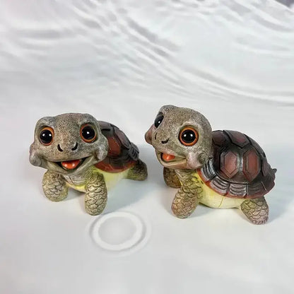 Two adorable crawling turtle sculptures with detailed gray and brown shells and expressive orange eyes for garden decorbites decor