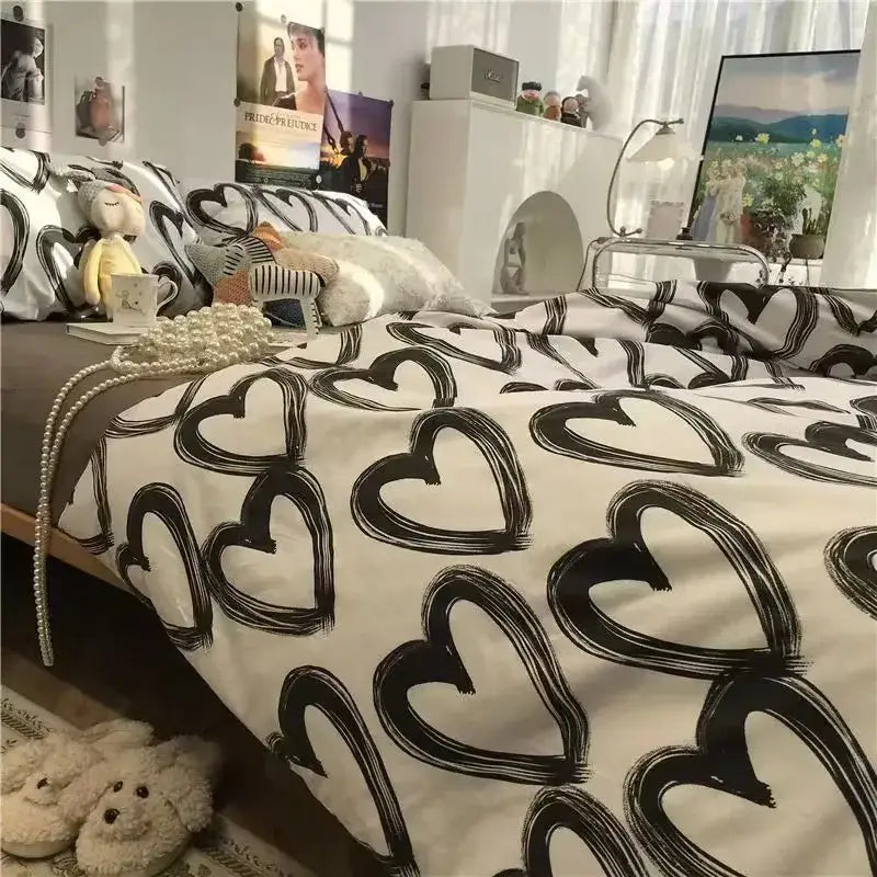White bedspread with bold black brushstroke hearts in checkerboard black and beige satin duvet cover set bedroom bedding