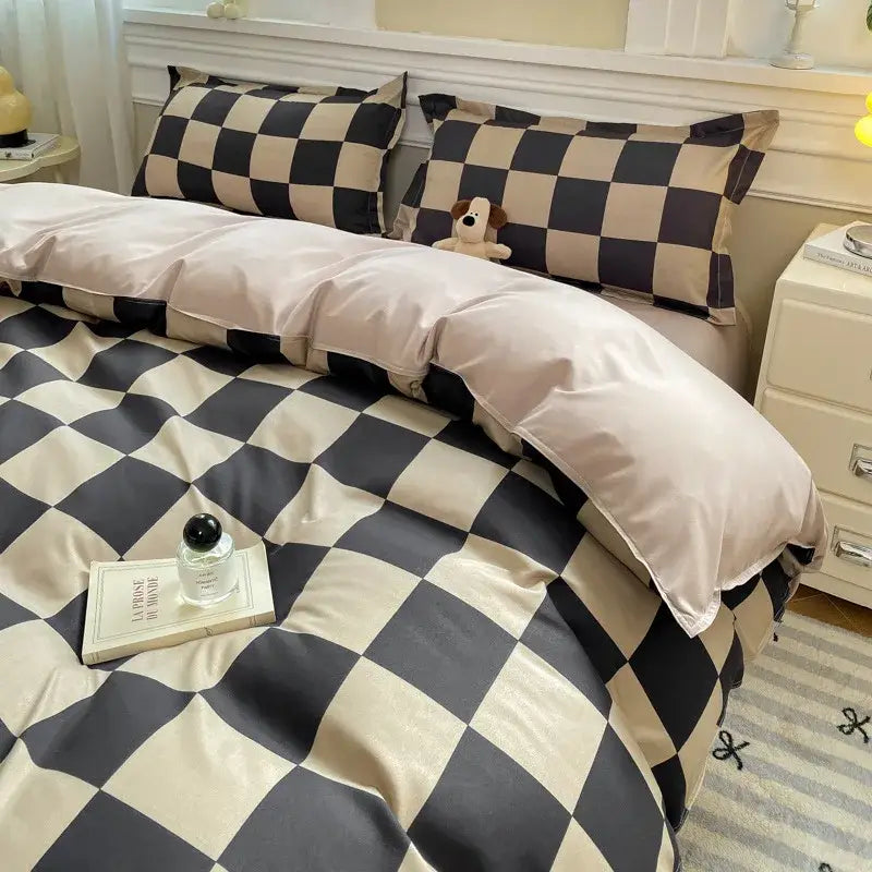 Checkerboard black and beige satin duvet cover set with plush stuffed dog nestled in pillows for bedroom bedding