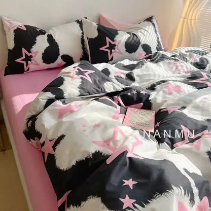 Checkerboard black and beige satin duvet cover set featuring black and white cow print with pink star accents for bedroom bedding