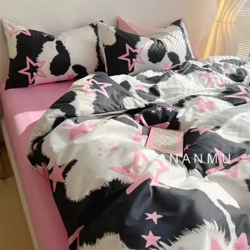 Checkerboard black and beige satin duvet cover set featuring black and white cow print with pink star accents for bedroom bedding