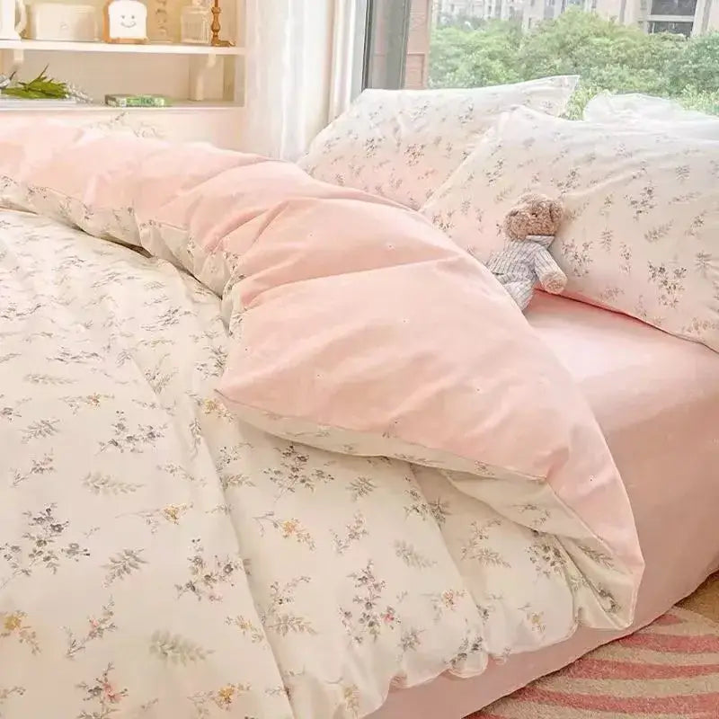 Soft pink floral duvet cover with pastel pattern and plush texture in a checkerboard black and beige satin duvet cover set