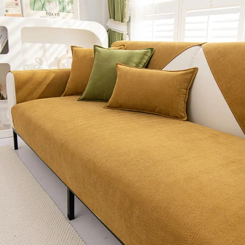Mustard-yellow chenille textured non-slip sofa cover with herringbone pattern and olive green sofa cushions for living room