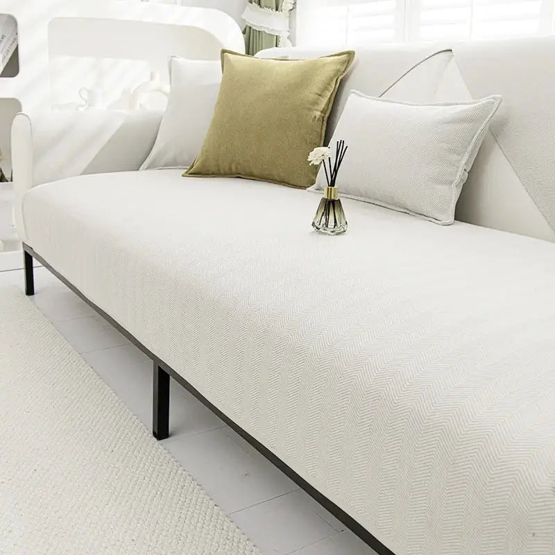 White chenille textured non-slip sofa cover with herringbone pattern and black metal legs for living room sofa cushion