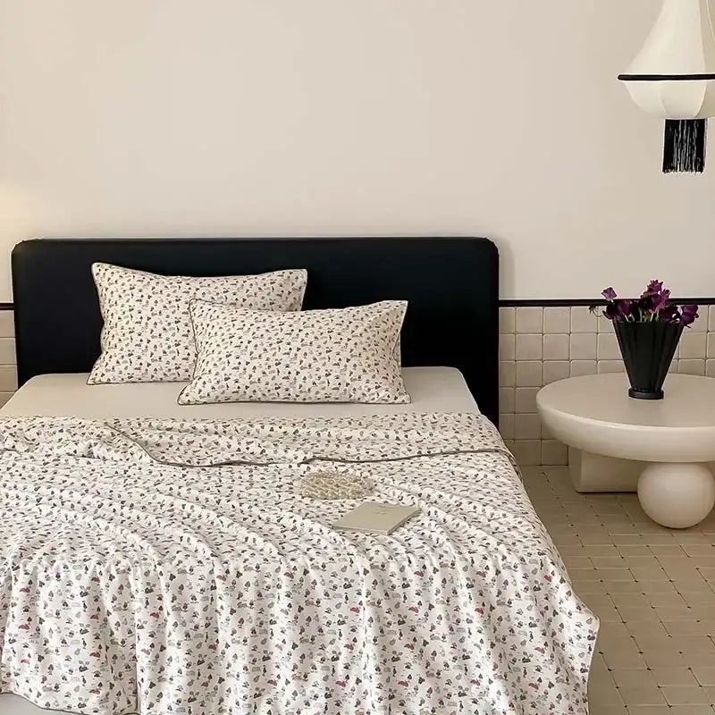 White bedding set with delicate floral pattern and matching pillowcases featuring the decorbites cooling quilt design