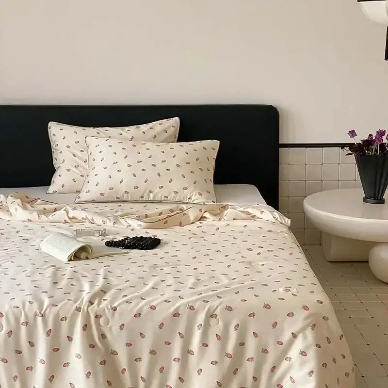 Cream-colored satin bedding set with delicate strawberry print featuring decorbites cooling quilt for bedroom decor