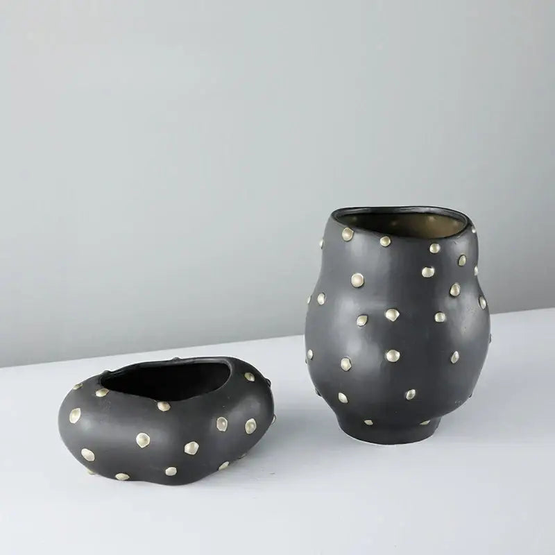Black resin flower pot with gold accent featuring a black ceramic vase with silver metallic studs for living room decorbites black resin decor
