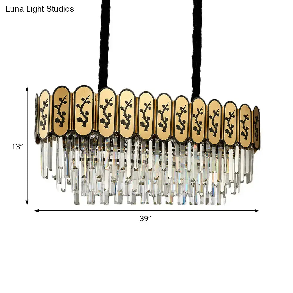 Gold-toned crystal shaded hanging lamp with oval black floral panels and clear crystal prisms for gold island dining room