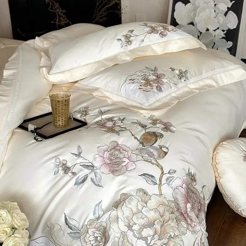 Cream-colored satin bedding set with intricate chinese flowers bird embroidery in soft pink mauve and gray tones