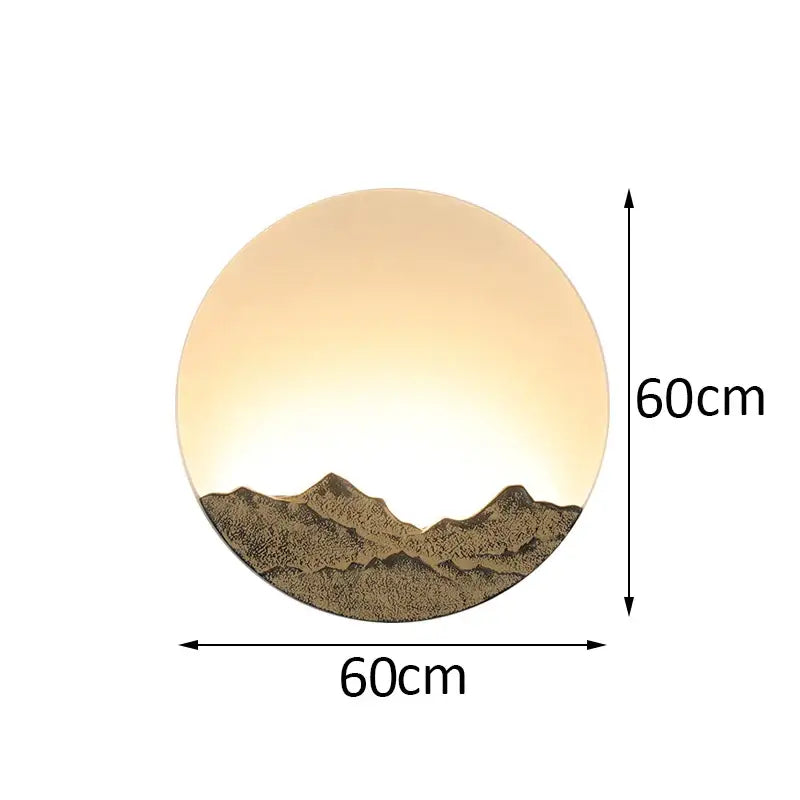 Circular bronze and gold decorbites led wall light with warm amber glow and textured mountain silhouette for living room