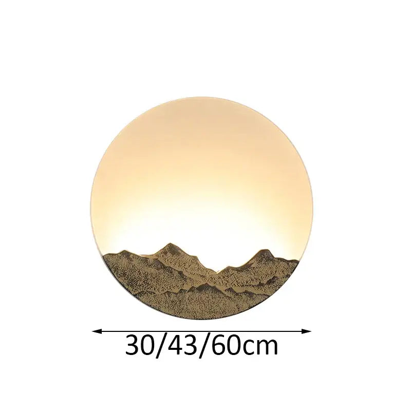 Circular wall light with warm glow and embossed chinese mountain silhouette in bronze and gold decorbites led wall light