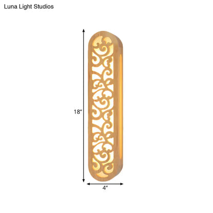 Chinese style beige carved wood wall light fixture with ornate gold-toned metal frame and intricate scrollwork patterns