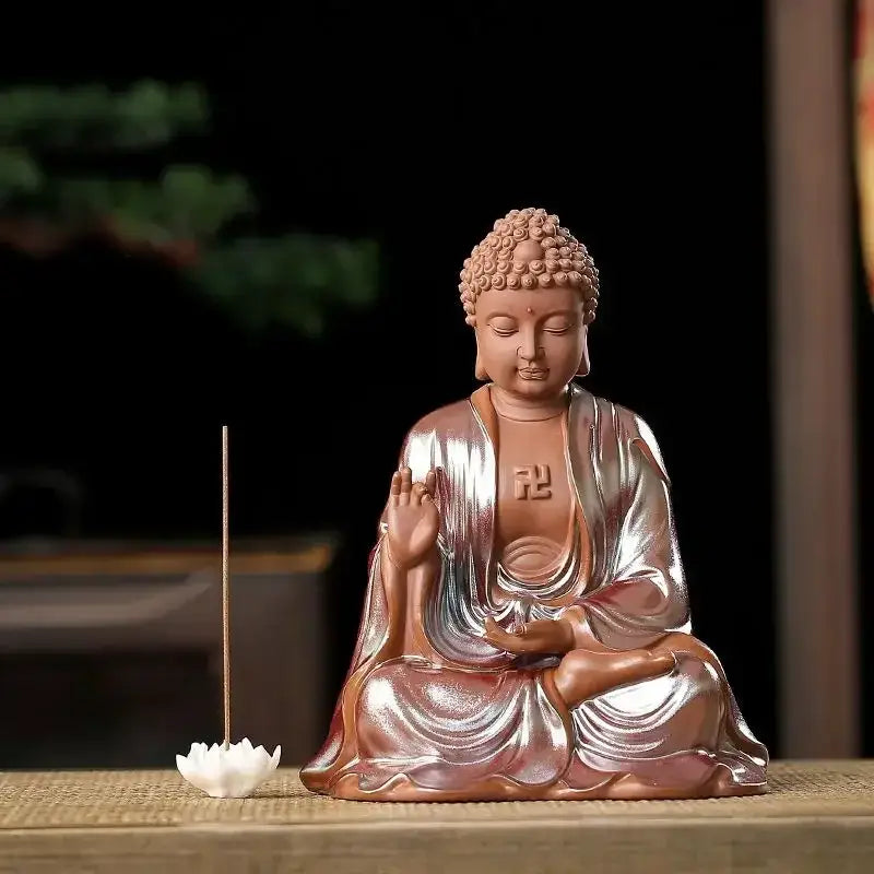 A serene ceramic sakyamuni buddha statue with glossy bronze and silver finish and intricate robes for living room decor