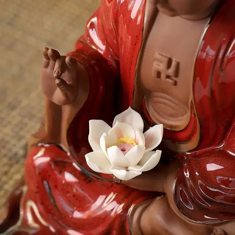 Glossy red ceramic sakyamuni buddha statue holding white lotus flower for living room bronze and silver style decor