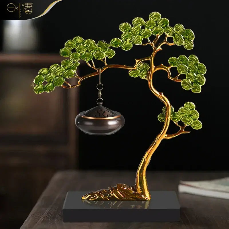 Golden enamel pine ornaments tree sculpture with green branches and dark bronze incense burner on black base