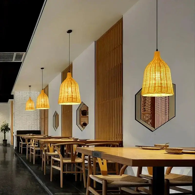 Warm golden-hued bamboo weave pendant lamp made of natural rattan hanging as dining room lighting