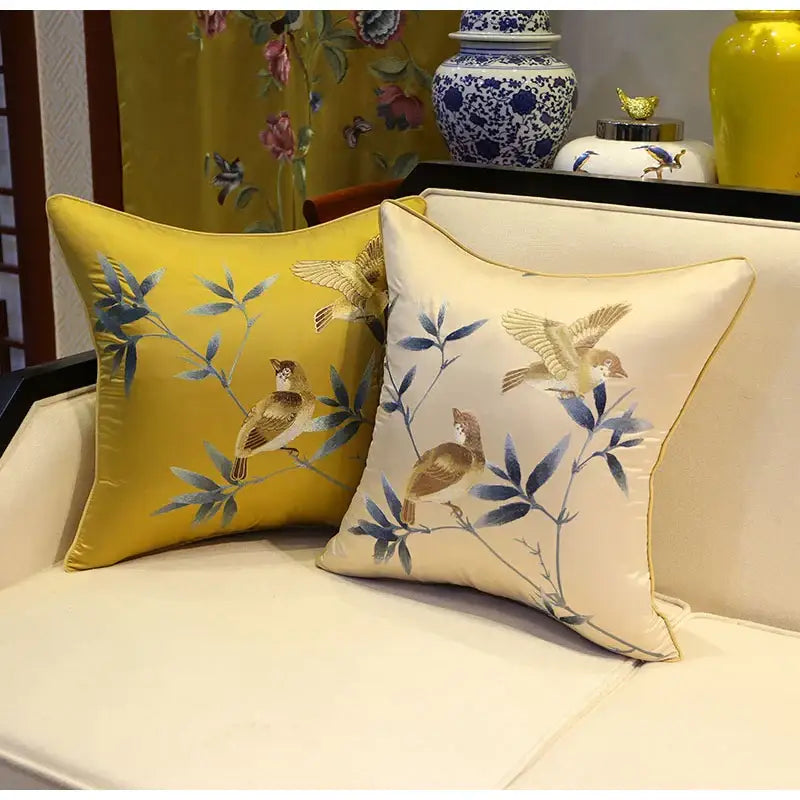 Two embroidered silk pillow covers in golden yellow and beige with decorbites birds branches embroidery for living room decor