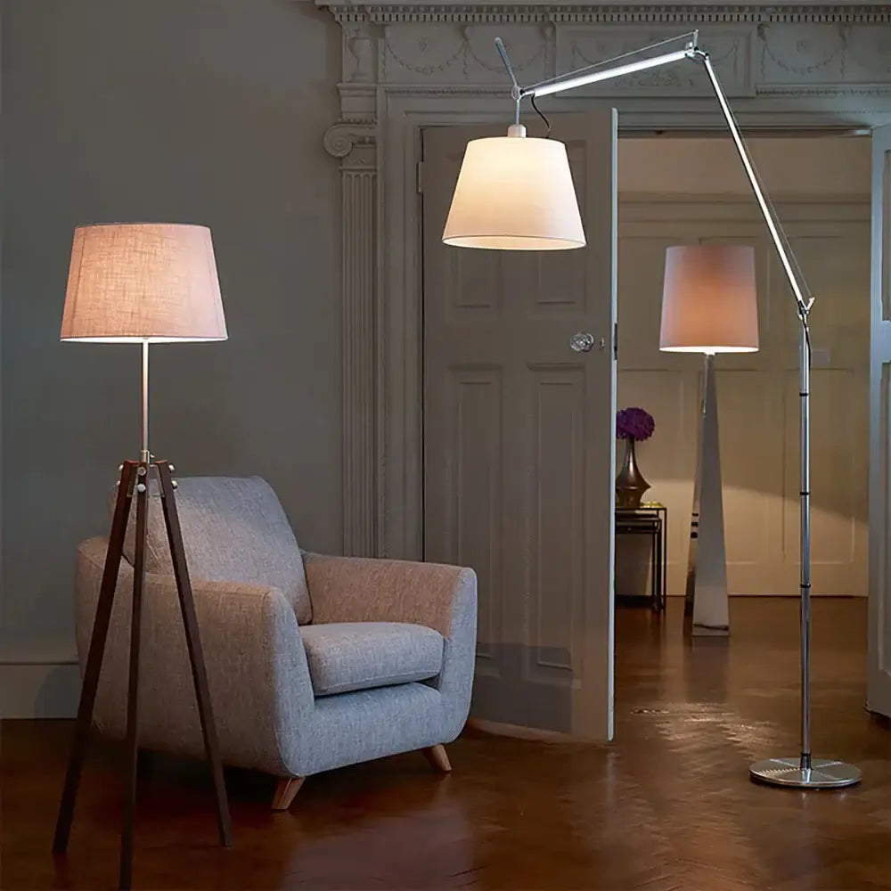 A chrome adjustable industrial wall light with a wide off-white fabric shade for modern bedroom decorbites decor