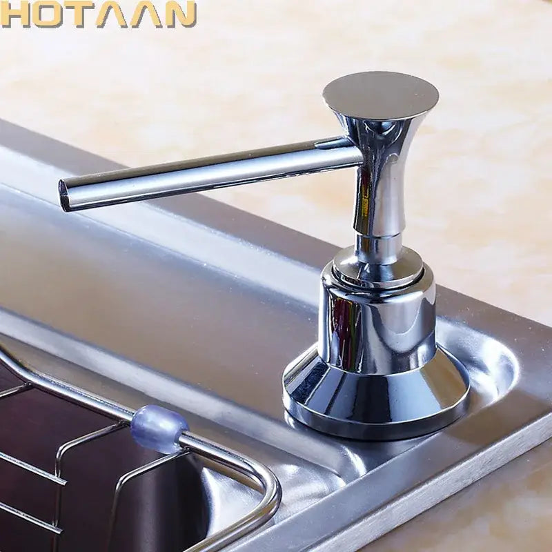 Chrome brass head stainless steel soap dispenser with sleek modern design and flat-top pump for kitchen sink use