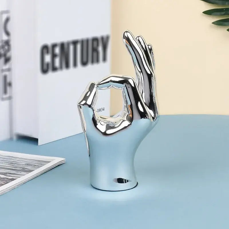 Three glossy gold-handled chrome ceramic love gesture figurine sculptures for stylish living room decor