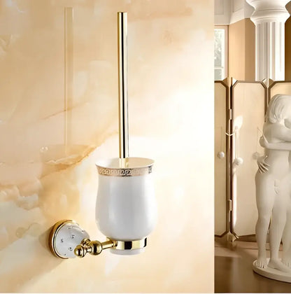 White ceramic toilet brush holder with gold-toned accents and greek key pattern mounted wall for bathroom hardware set