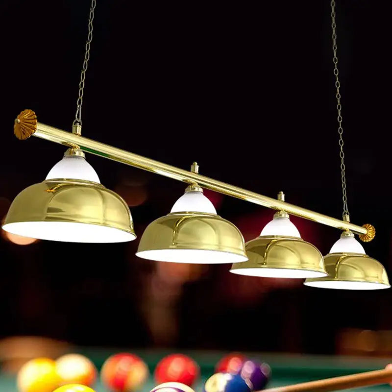 Brass-finished stainless steel billiard light with four dome-shaped shades and chain suspension for game room ceiling