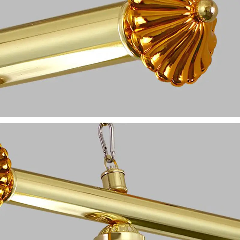Gold-colored brass curtain rod with decorative fluted finial and carabiner hook for hanging near stainless steel billiard light