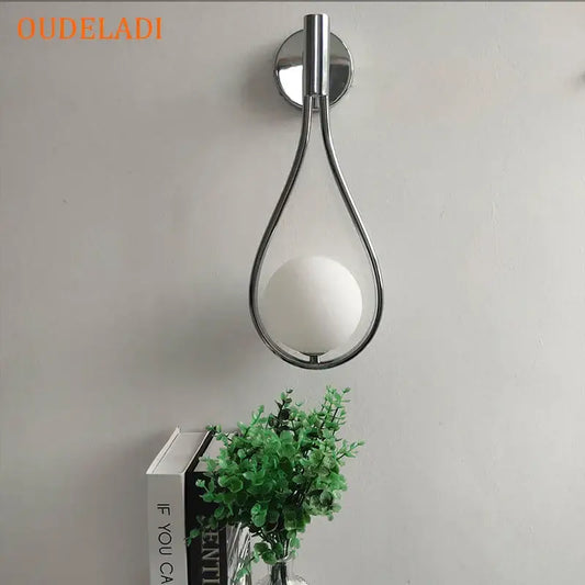 Chrome teardrop wall sconce with frosted white glass ball featuring chrome finish for bedroom decor with decorbites black glass
