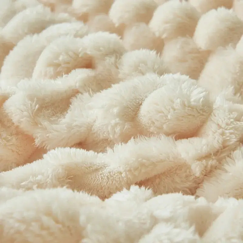 Chunky knit cream coral fleece blanket with a plush, fuzzy surface ideal as a cozy bedroom fleece blanket throw