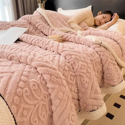 Chunky knit cream and black coral fleece blanket with pink plush textured throw and cream-colored fleece blanket lining