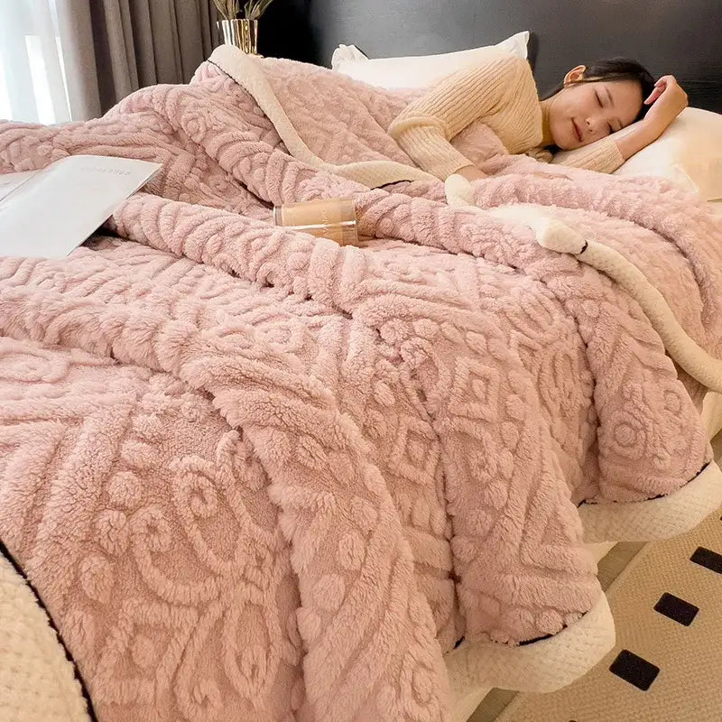 Chunky knit cream and black coral fleece blanket with pink plush textured throw and cream-colored fleece blanket lining