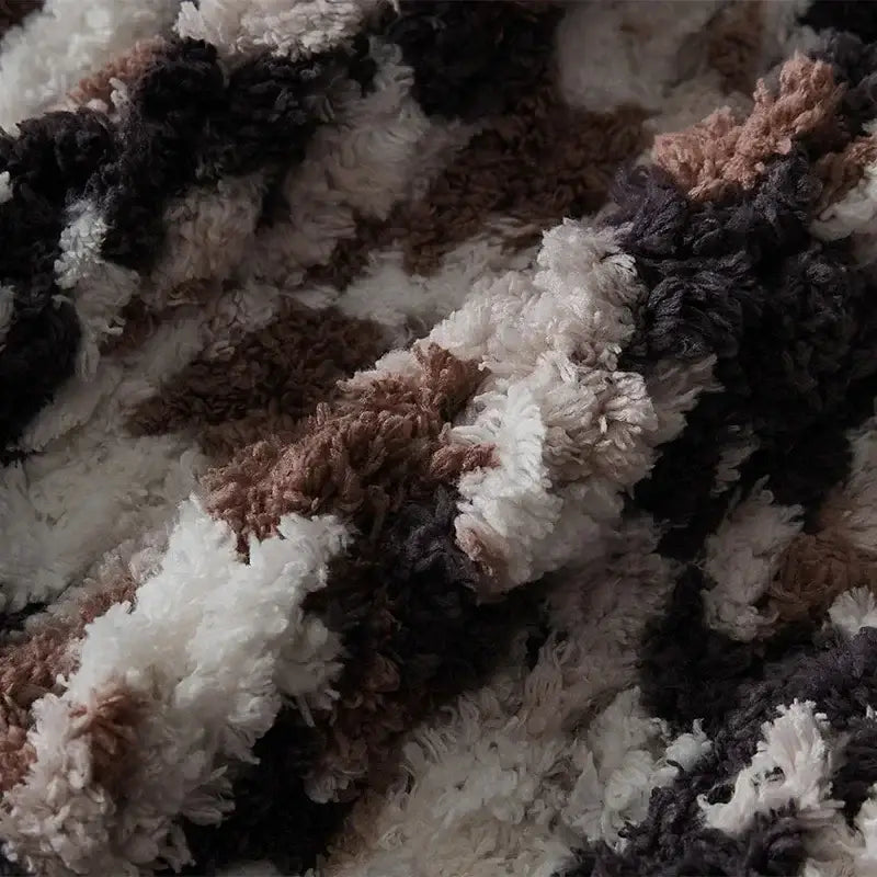 A cozy chunky knit jacquard blanket throw in white beige dark gray and brown tones for living room decor