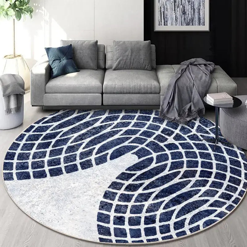 Circular geometric cashmere floor mat with bold navy blue and white interlocking tile pattern and textured surface