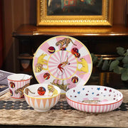 Pink and white striped ceramic tableware set featuring decorbites circus troup kids illustrations of tigers lions and acrobats