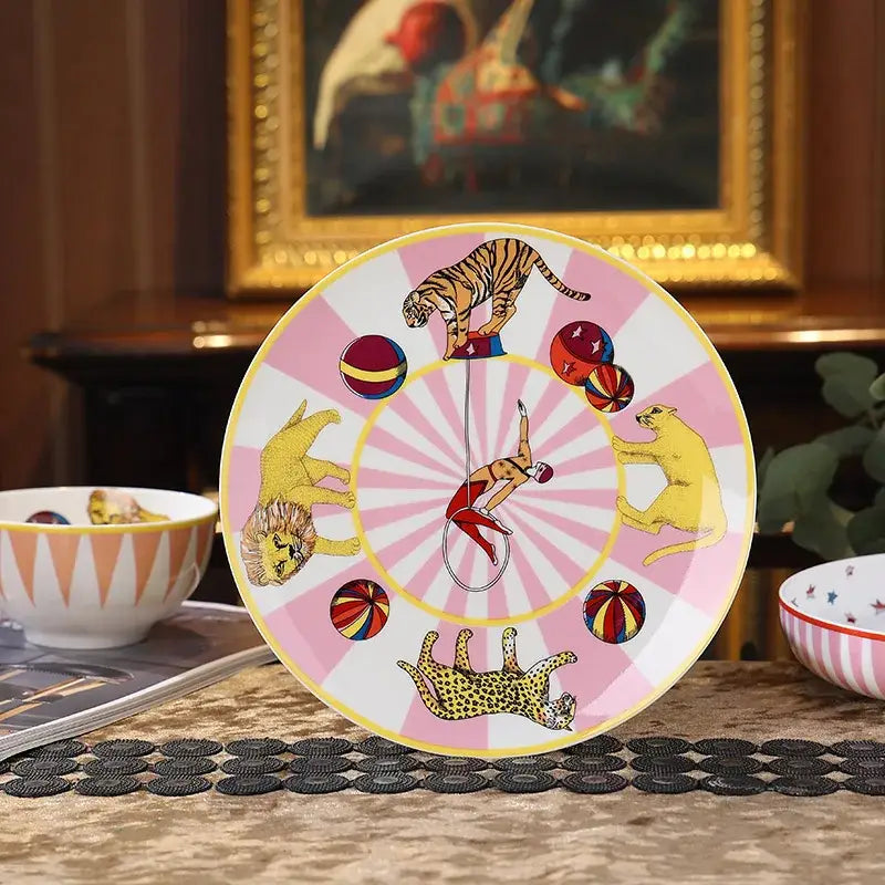 Vibrant pink and white ceramic tableware set with acrobat and wild animals decorbites circus troup kids design