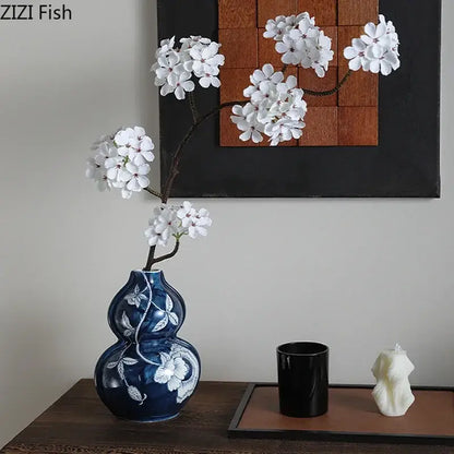 Classic blue porcelain vase shaped like traditional gourd with white floral vine patterns for living room decorbites blue porcelain