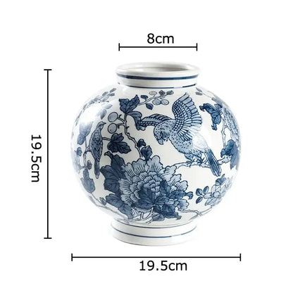 A round white ceramic decorbites blue porcelain vase with intricate blue bird and floral designs for living room decor