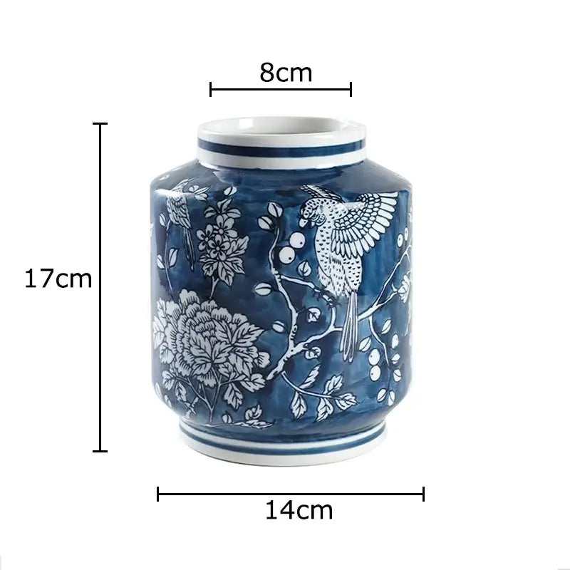 A blue porcelain vase with intricate bird and floral designs and glossy finish perfect for living room decorbites blue porcelain decor