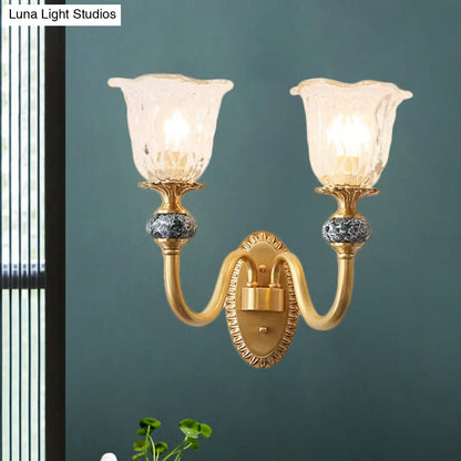 Classic Brass Floral Wall Sconce with Clear Ribbed Glass and Swooping Arm - 1/2-Head Wall Mount Lamp
