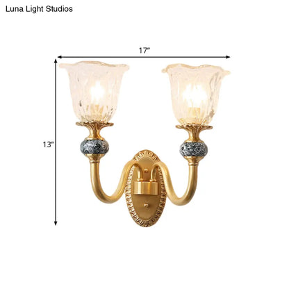 Classic Brass Floral Wall Sconce with Clear Ribbed Glass and Swooping Arm - 1/2-Head Wall Mount Lamp