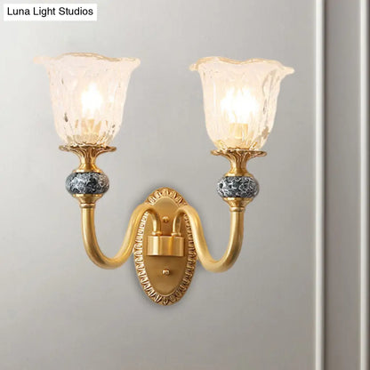 Classic Brass Floral Wall Sconce with Clear Ribbed Glass and Swooping Arm - 1/2-Head Wall Mount Lamp