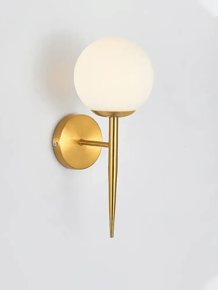 Classic brass glass wall sconce with gold-toned slender stem and frosted glass globe for bedroom decorbites brass glass