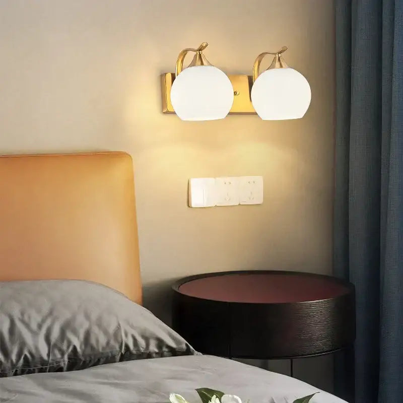 Classic brass glass wall sconce with gold-toned twin globe frosted glass shades for bedroom decorbites brass glass design