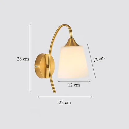 Classic brass glass wall sconce with gold-toned curved arm and frosted shade for bedroom by decorbites brass glass