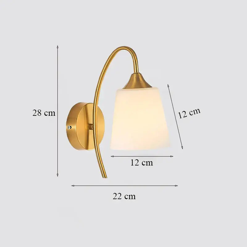 Classic brass glass wall sconce with gold-toned curved arm and frosted shade for bedroom by decorbites brass glass