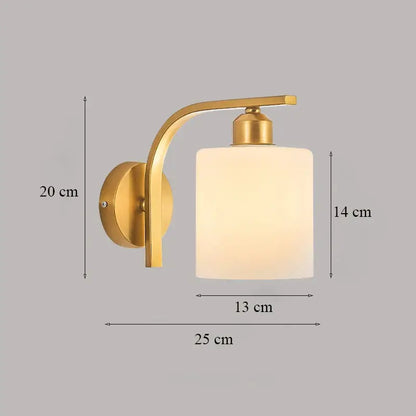 Classic brass glass wall sconce with gold-toned curved arm and frosted glass cylinder shade for bedroom decorbites brass glass
