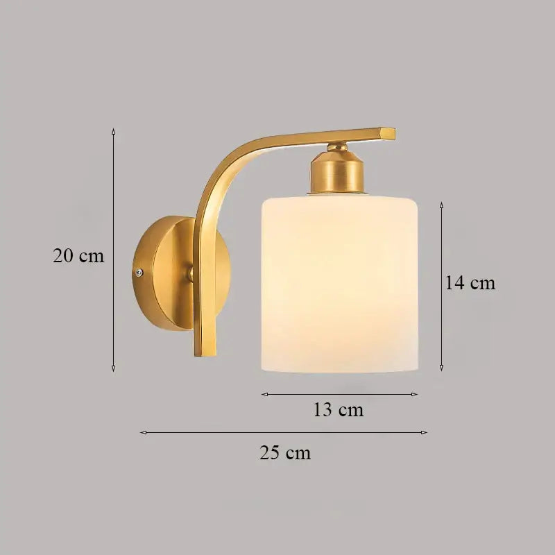 Classic brass glass wall sconce with gold-toned curved arm and frosted glass cylinder shade for bedroom decorbites brass glass